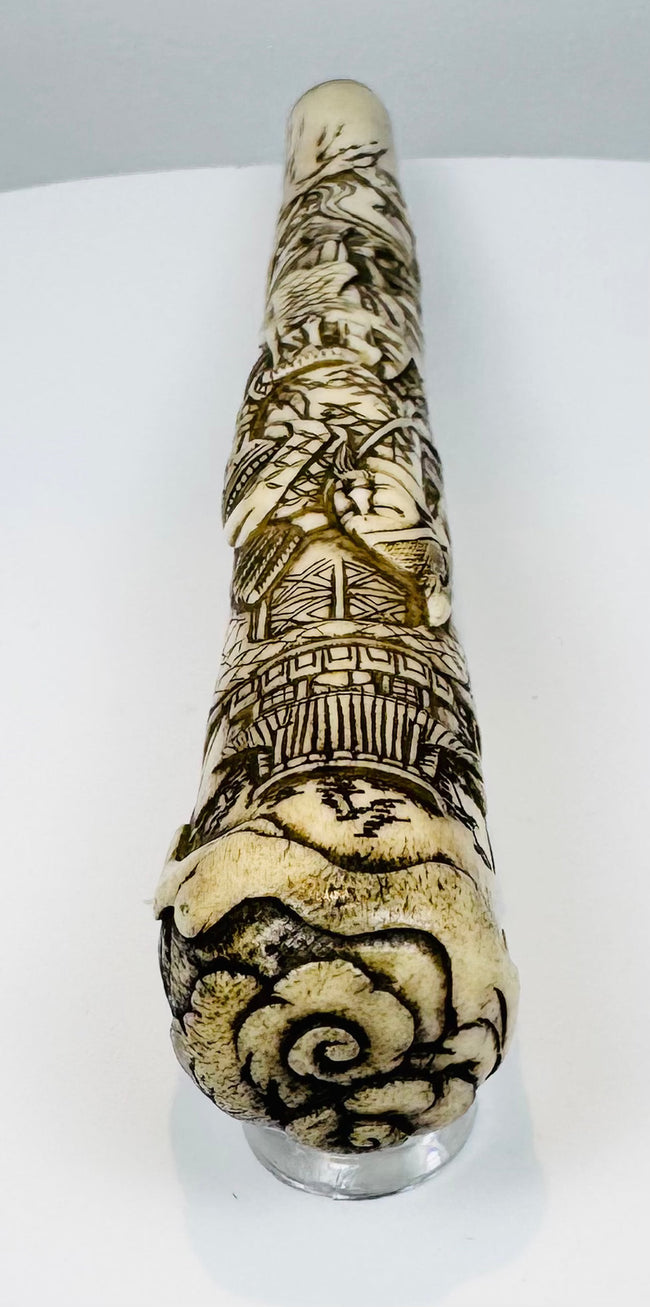 Cylindrical Japanese bone fitting with continuous architectural and figural carving