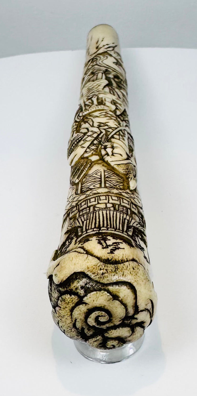 Cylindrical Japanese bone fitting with continuous architectural and figural carving