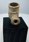 Side view of antique African pottery pipe bowl with projecting stem opening