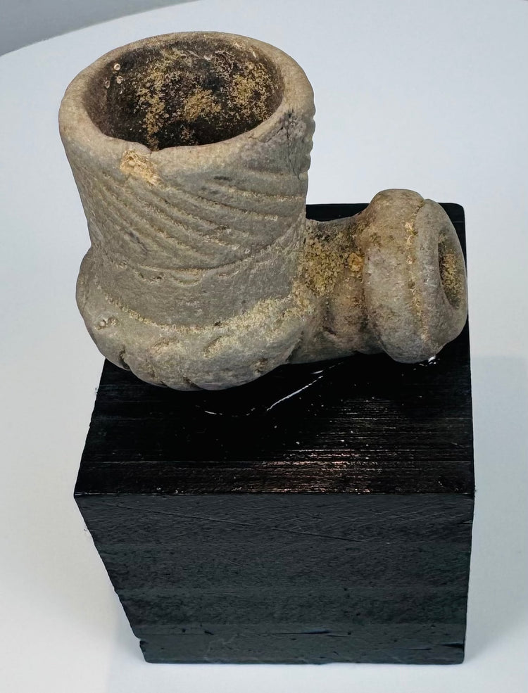 Side view of ancient stone elbow pipe with deep cylindrical smoking bowl