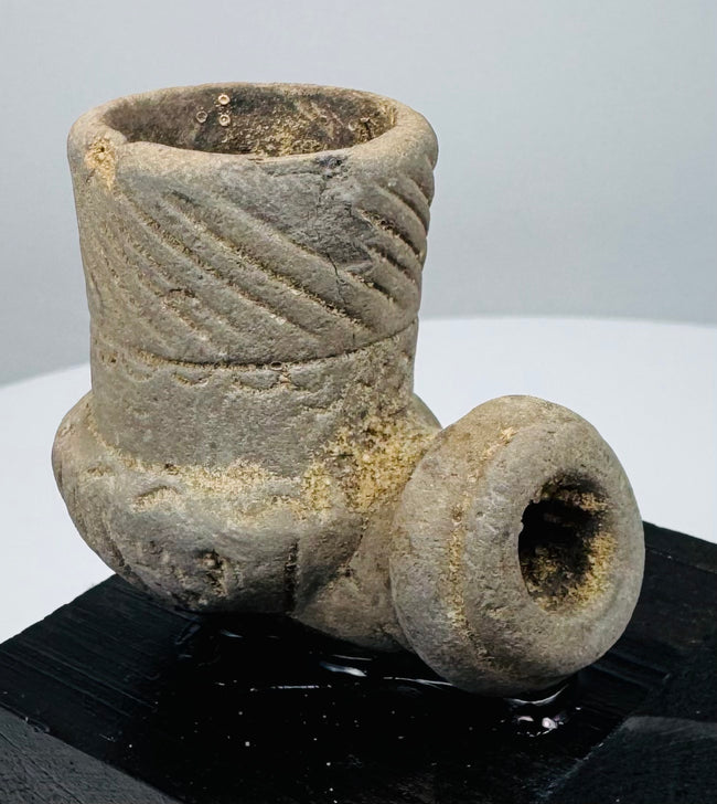 Compact Eastern Woodlands-style stone smoking pipe mounted on a modern display base