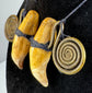 Pair of possible tiger canine teeth mounted with traditional Naga brass spirals