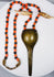 Antique Konyak prestige jewellery with stylized shell-form brass pendant and trade beads