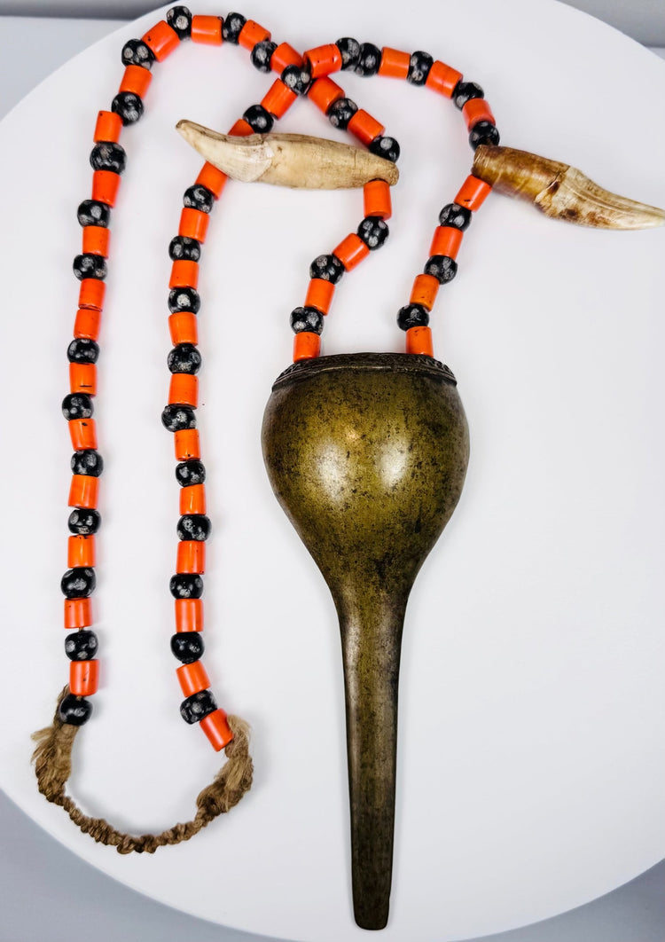 Antique Konyak prestige jewellery with stylized shell-form brass pendant and trade beads