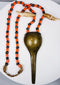 Antique Konyak prestige jewellery with stylized shell-form brass pendant and trade beads