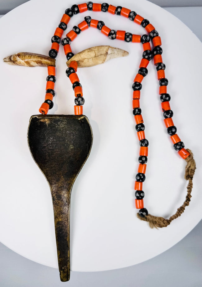 Naga warrior adornment with large brass pendant, paired animal teeth and colourful glass beads