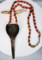 Naga warrior adornment with large brass pendant, paired animal teeth and colourful glass beads