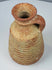 Base view of a Roman terracotta juglet showing its recessed circular foot and aged deposits