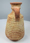 Side view of a Roman pottery vessel showing its rounded shoulder and loop handle