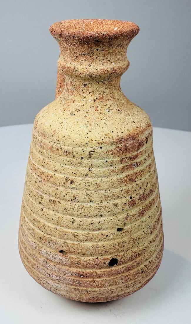 Ancient earthenware juglet with closely spaced horizontal wheel ridges around the body