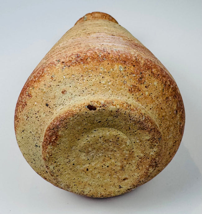 Small ancient Mediterranean pottery jug with buff clay fabric and reddish surface coloration