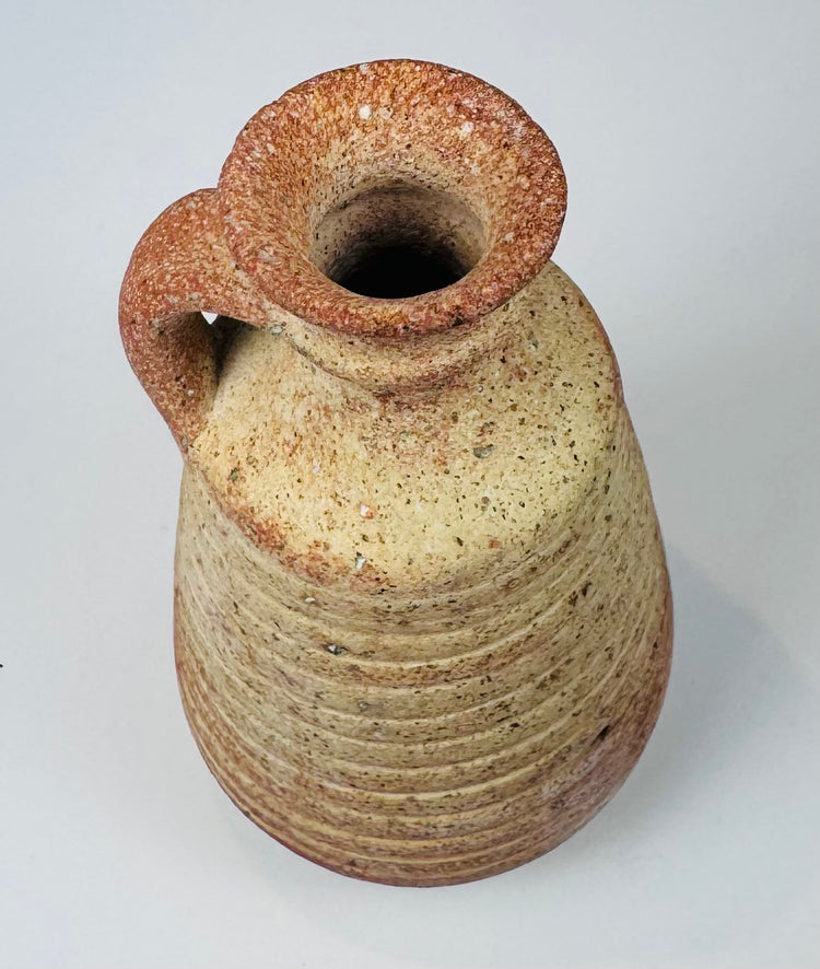 Rear view of an ancient Roman juglet showing its intact applied pottery handle