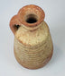 Rear view of an ancient Roman juglet showing its intact applied pottery handle