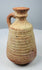 Roman–Late Antique pottery jug with ribbed body and reddish-buff clay surface