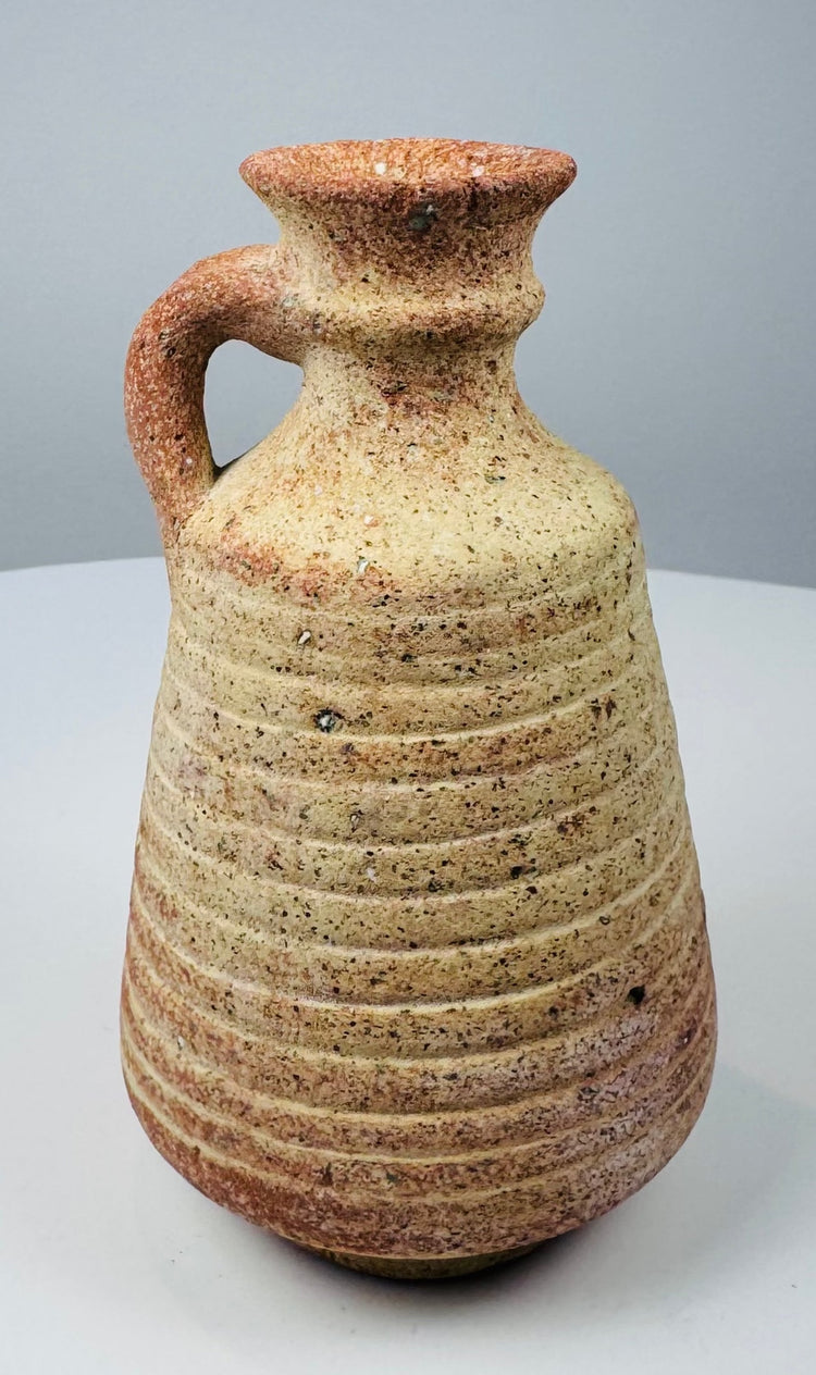 Roman–Late Antique pottery jug with ribbed body and reddish-buff clay surface