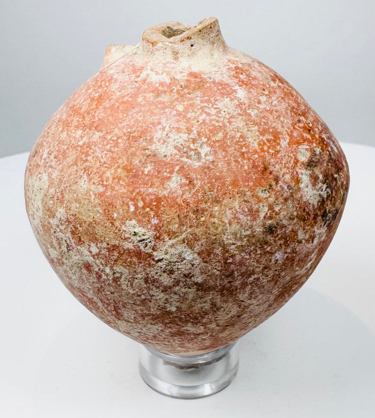 Top view of an ancient Roman feeding vessel showing its small circular filling aperture