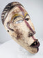 Hand-carved Lower Congo mask displaying aged pigment, abrasions and surface patina