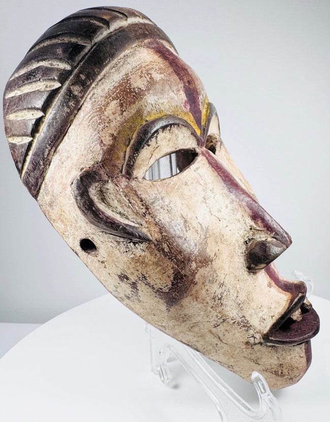 Detailed view of a Central African mask with pierced eyes and individually carved teeth