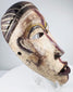 Detailed view of a Central African mask with pierced eyes and individually carved teeth