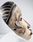 Expressive Yombe cultural mask with cream-colored face and dark contrasting details