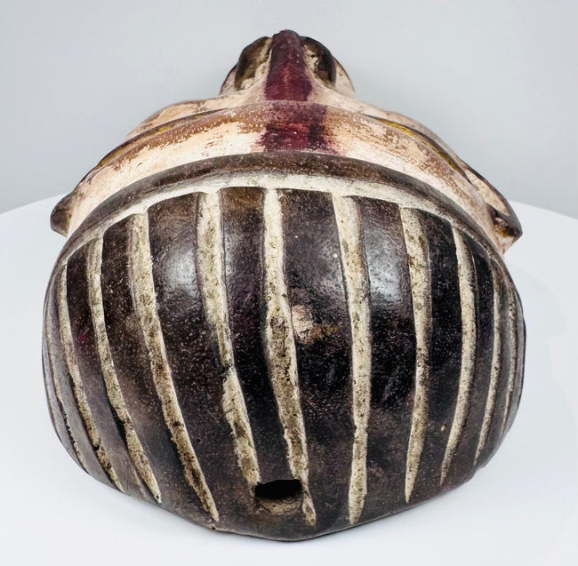 Historic Yombe-style mask with worn polychrome decoration and attachment holes