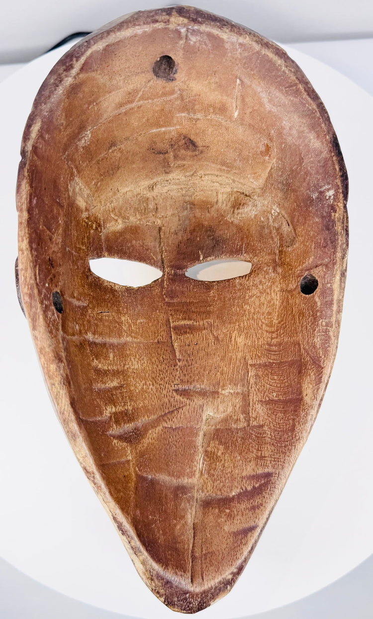Mid-century African ethnographic mask with elongated face and geometric coiffure
