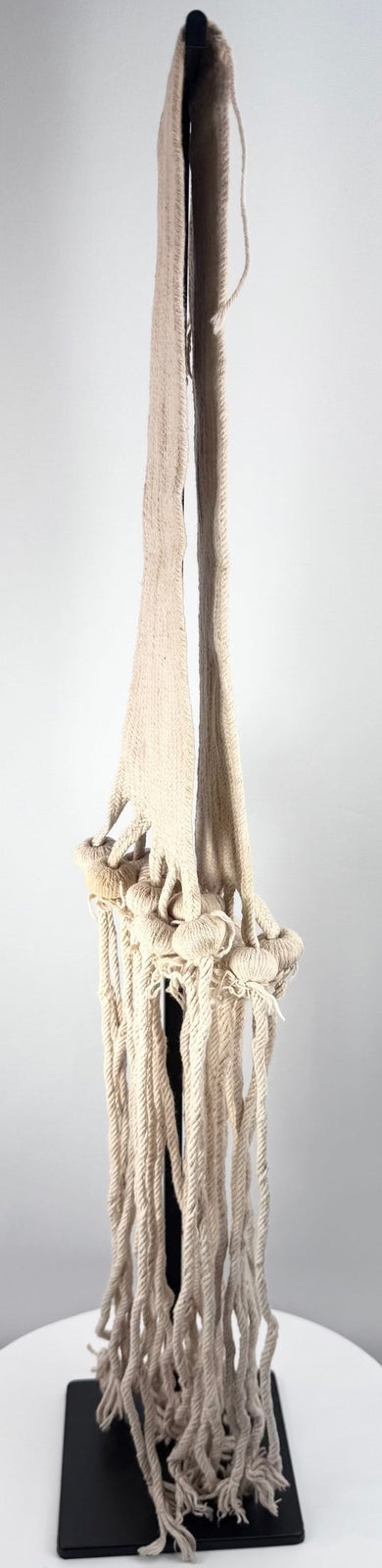 Full view of a small handwoven Pueblo rain sash mounted for preservation and display