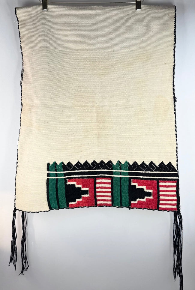 Detail of colourful Germantown wool embroidery on a cream-coloured Hopi-style dance kilt