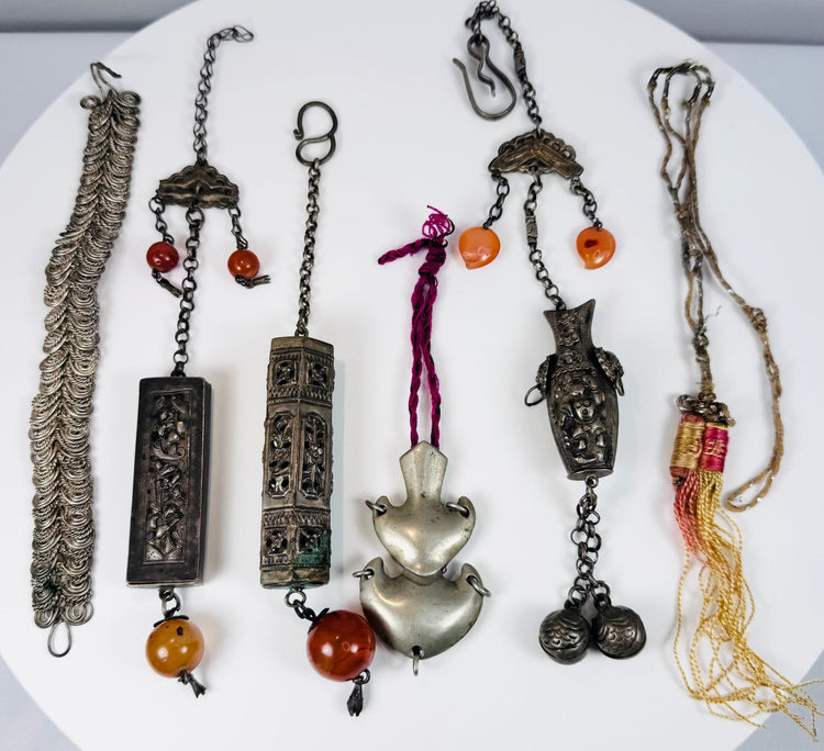 Group of six antique Chinese garment ornaments and amulets dating to the late Qing and early Republic periods