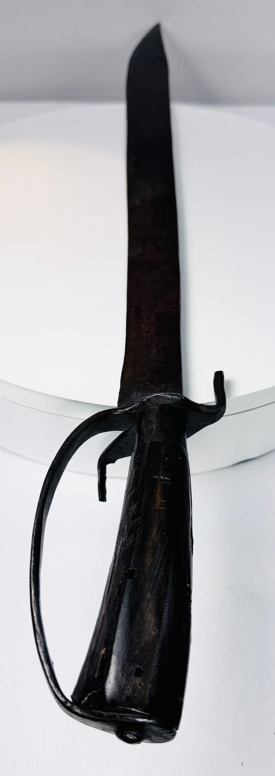 Wrought-iron D-shaped knuckle bow protecting the hilt of an early American backsword