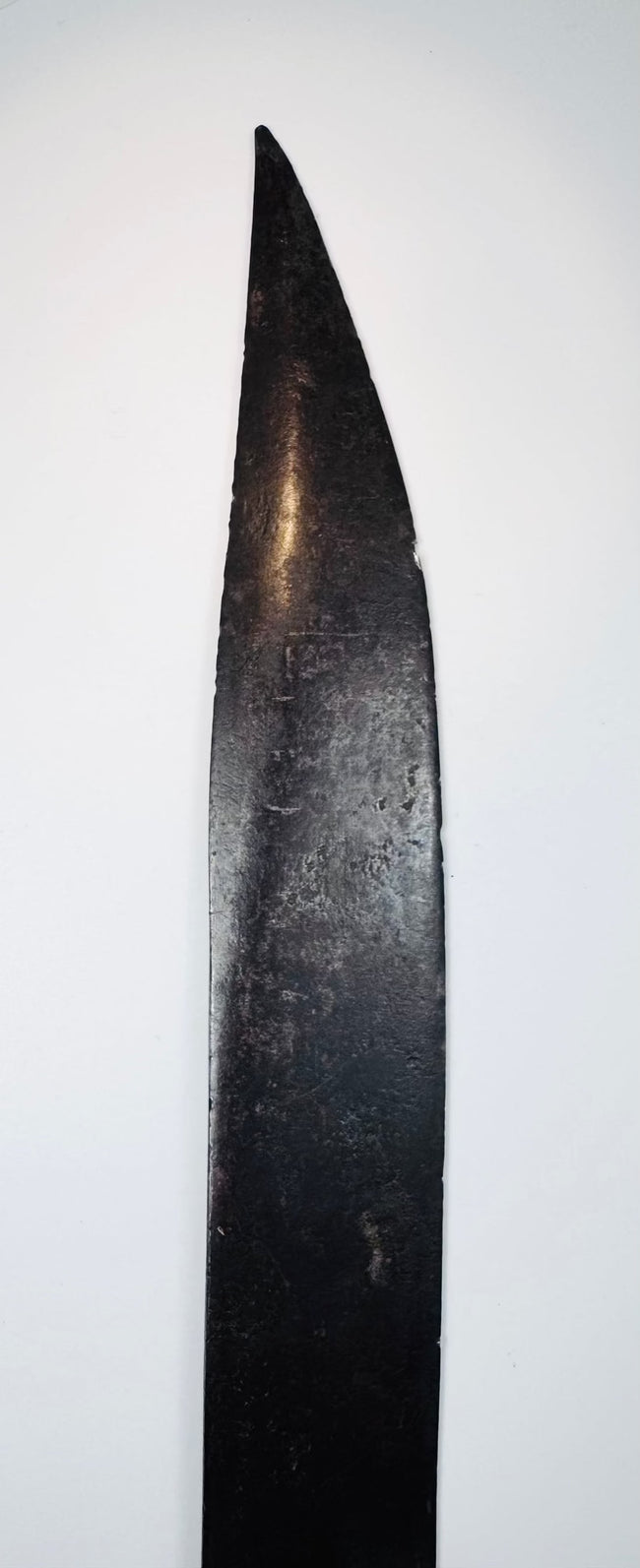 Close view of the hand-forged crossguard and short downturned quillons on a Colonial sword
