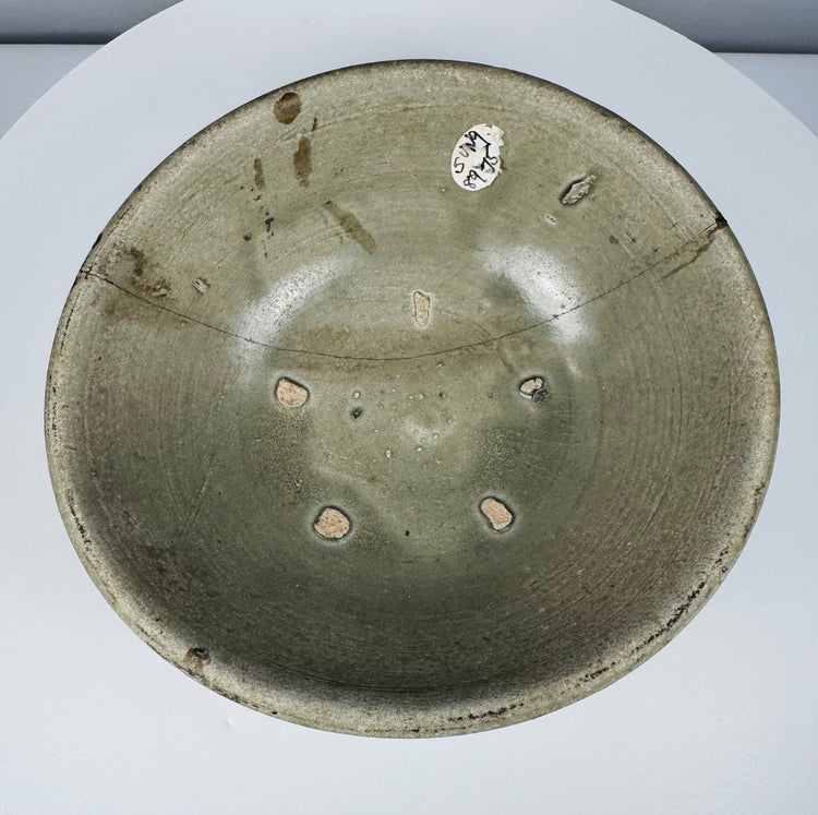 Underside of a Vietnamese celadon bowl with an unglazed reddish-brown foot and recessed base