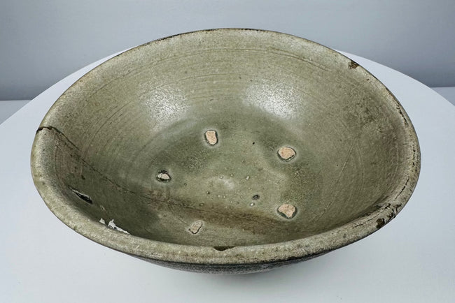 Interior view of a Vietnamese celadon bowl showing five exposed clay firing-spur marks