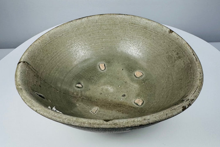 Interior view of a Vietnamese celadon bowl showing five exposed clay firing-spur marks