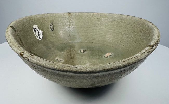 Detail of the gray-green celadon glaze and concentric throwing lines inside the bowl