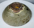 Detail of cracks, rim chips, glaze losses and surface deposits on an ancient celadon vessel