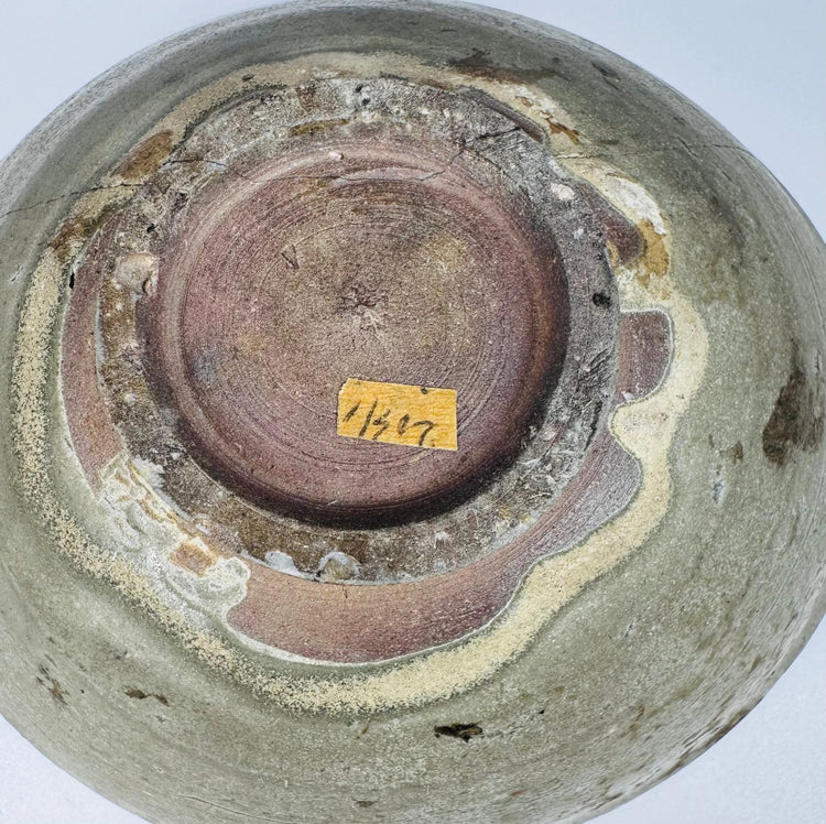 Historic white collection label preserved inside a 12th–14th-century Vietnamese bowl