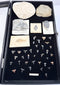 Full overhead view of a fossil collection containing trilobites, shark teeth, fossil fish and sedimentary stone