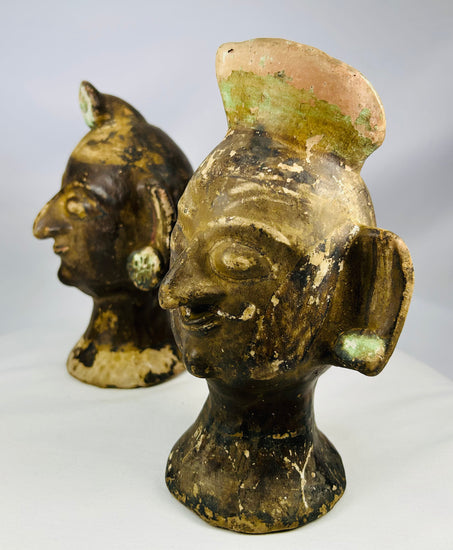 Central American inspired terracotta head figures with domed headdresses and expressive eyes