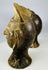 Hand-formed terracotta head sculptures with prominent ear ornaments and aged patina