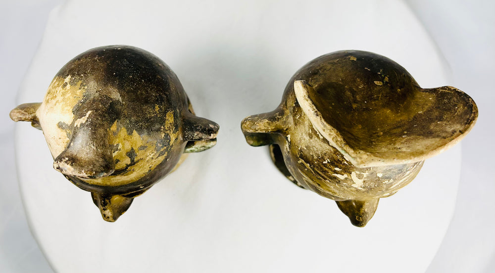 Matched pair of hollow terracotta head figures with expressive features and cultural inspiratio