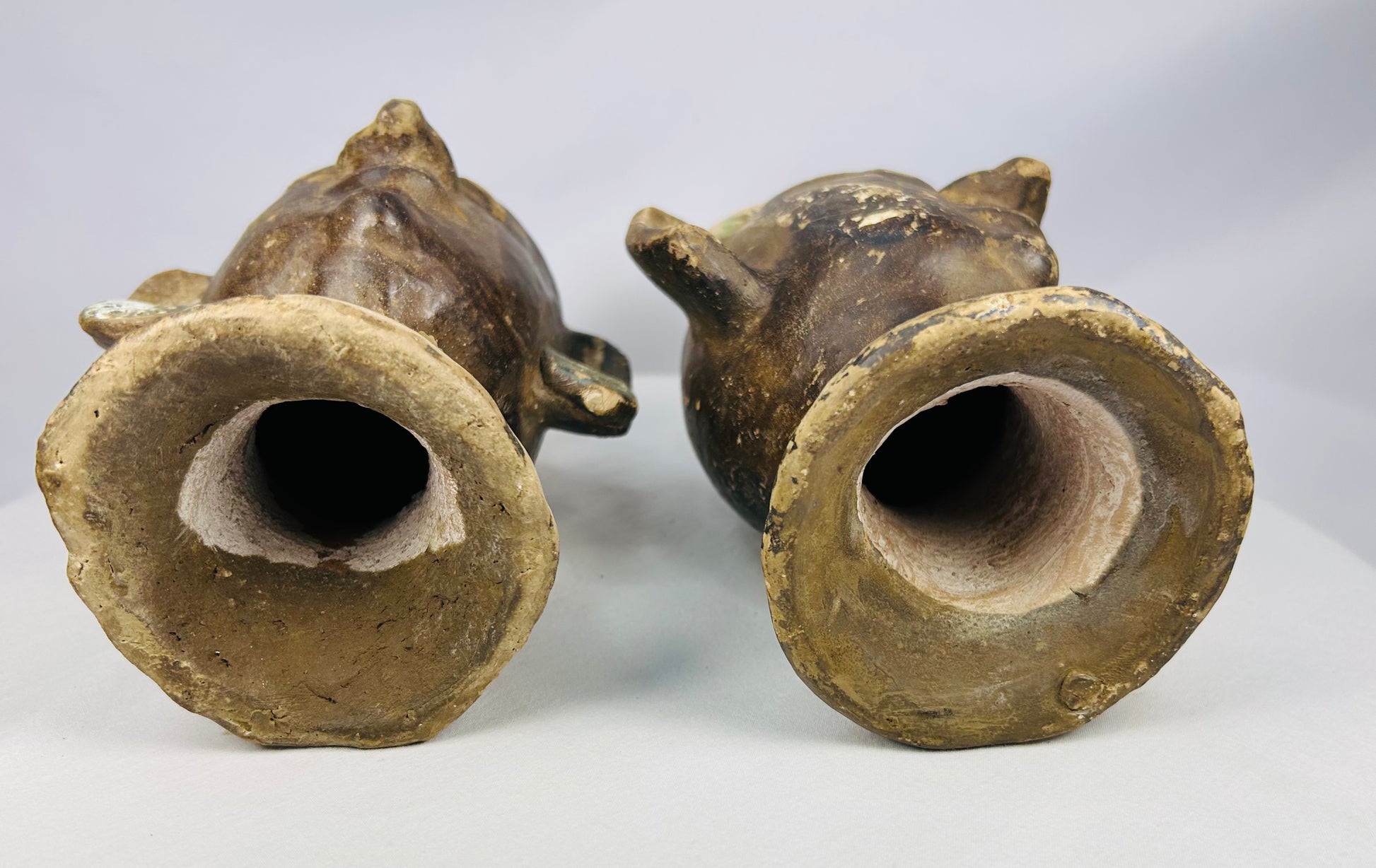 20th-century terracotta head sculptures with ritual-style headdresses and prominent ear discs