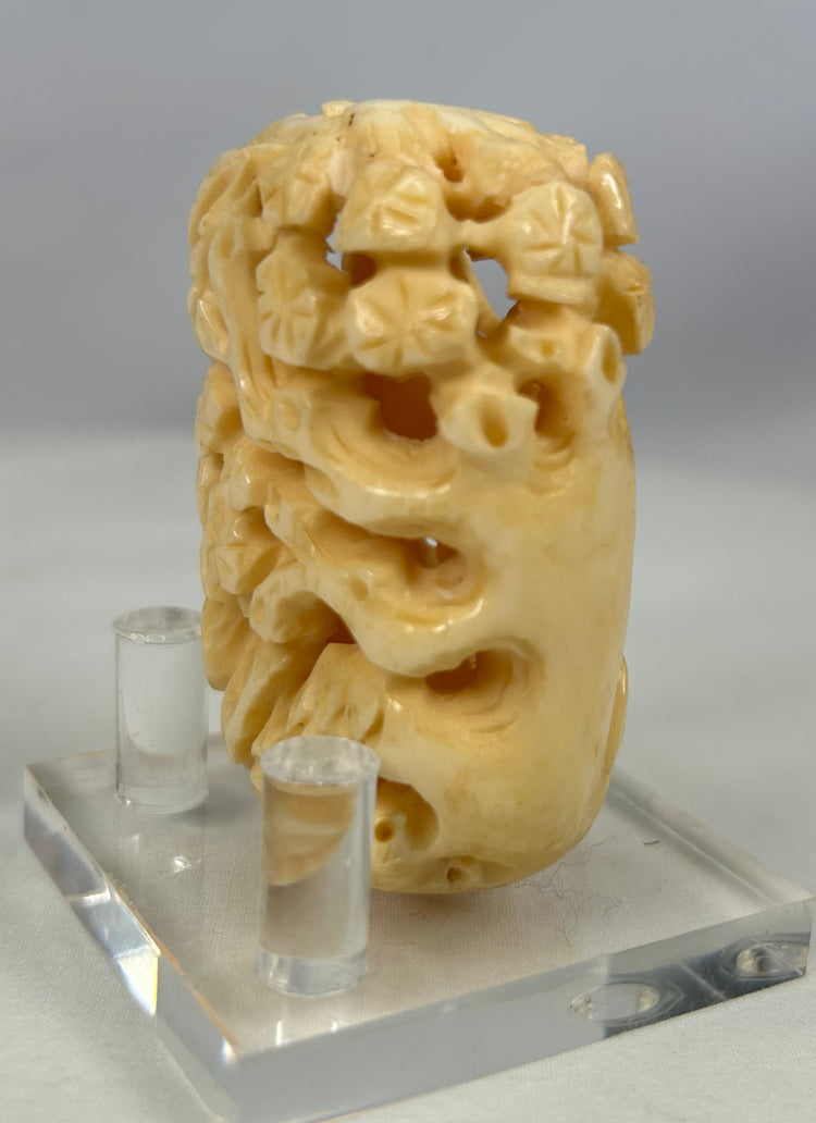 Antique Japanese openwork bone carving with sculpted birds and foliage in high relief