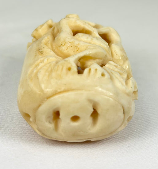 Elegant Japanese decorative bone ornament with pierced bird and plant design, early 20th century