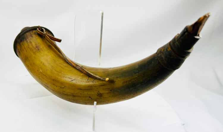 Authentic 1700s–1800s powder horn showing warm horn coloration and period wear