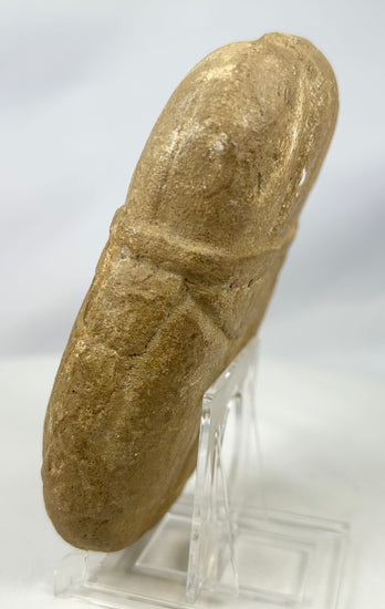 Rustic stone guardian figure with strong sculpted features and patina