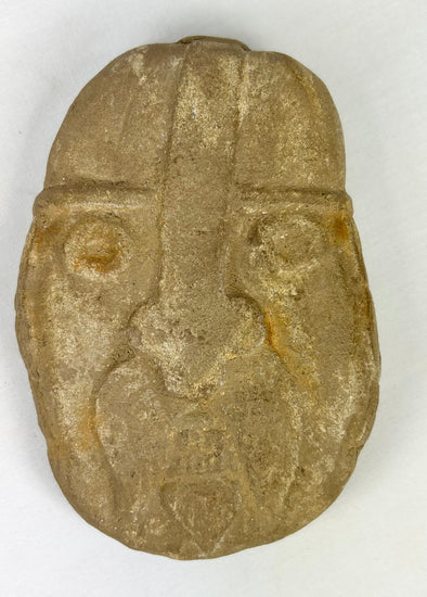 Protective guardian stone head sculpture with weathered surface