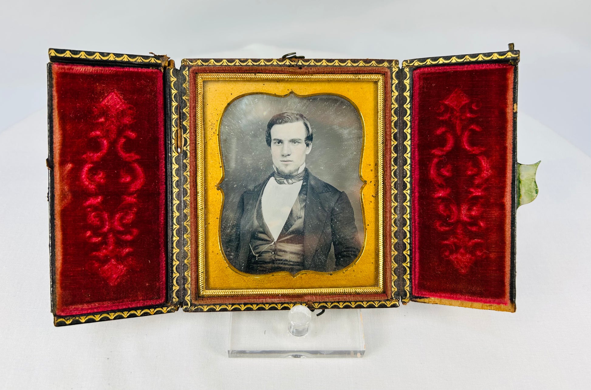 Antique cased daguerreotype-style portrait with ornate gilt mat and red velvet presentation case