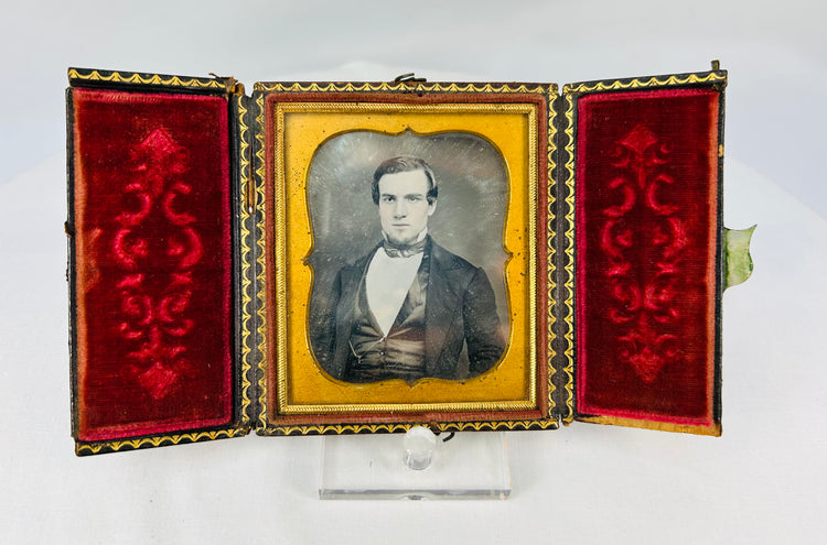Antique cased daguerreotype-style portrait with ornate gilt mat and red velvet presentation case