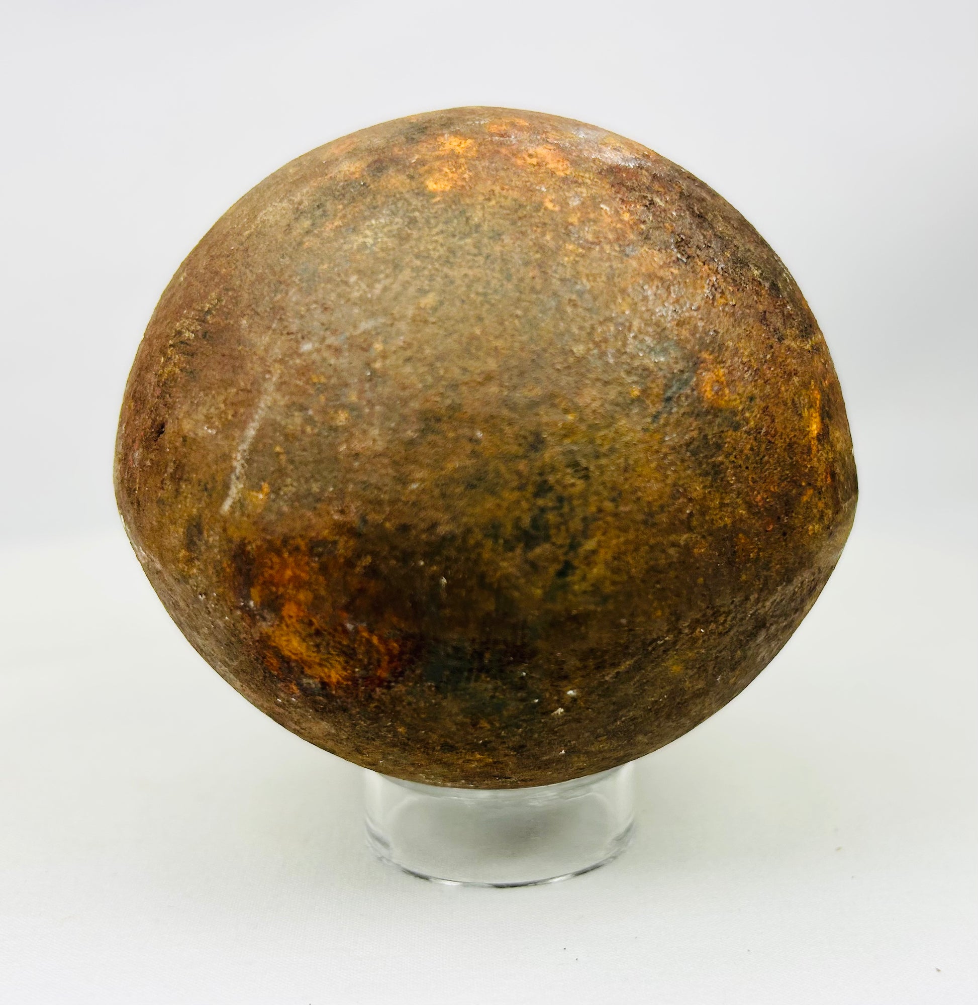 Authentic antique iron cannonball, likely military artillery shot, heavily weathered
